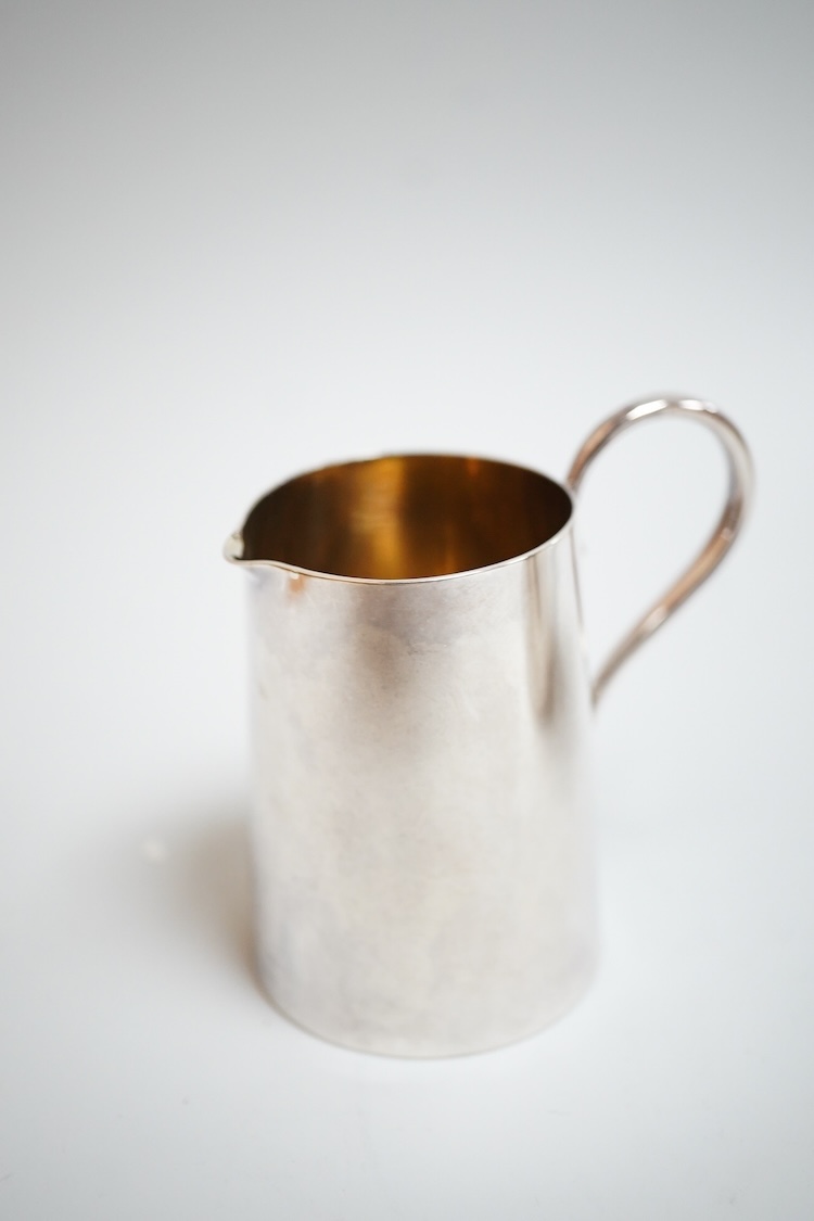 Sundry silver including two George V silver sauce boats, a silver café au lait pot, a small silver cream jug, three small silver dishes, a silver mounted glass sugar sifter and a silver mounted glass ashtray.